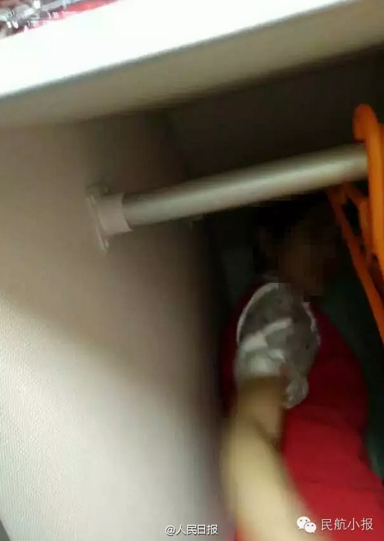 Air stewardesses packed into overhead bin