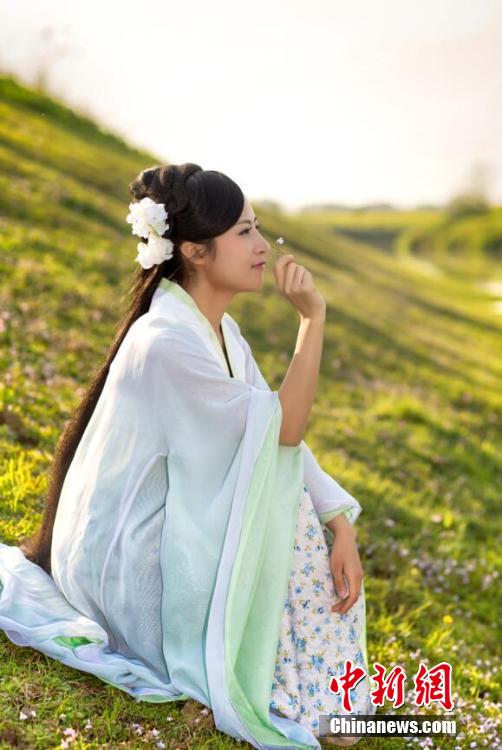 Female official wearing traditional Han costume to promote local tourism