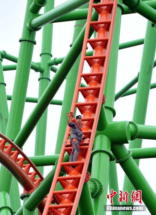Man successfully climbs up 77-meter-high roller coaster