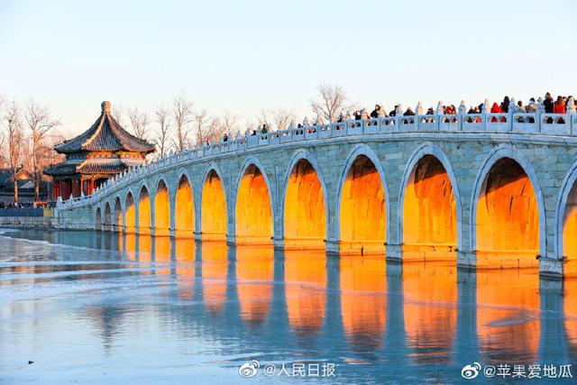 Stunning view of ancient bridge lit by golden winter sunshine at the Summer Palace in Beijing
