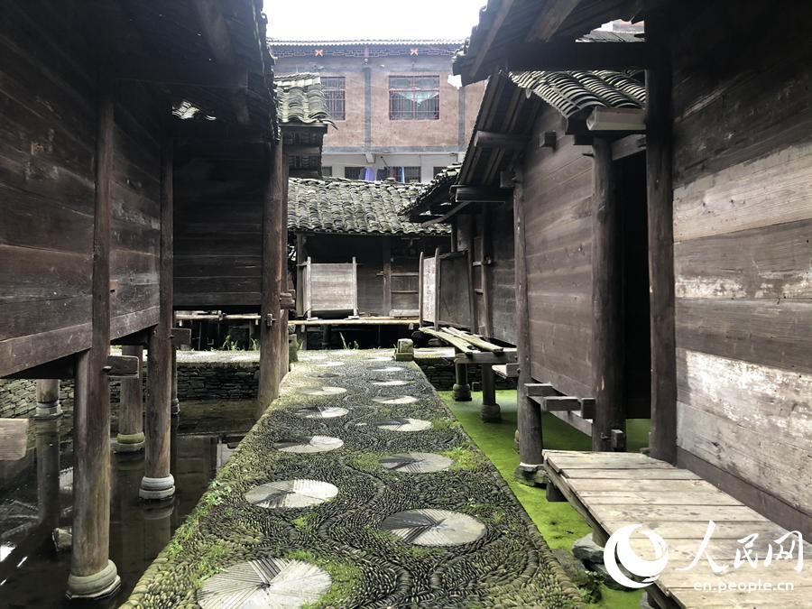 Barns built above water keep grain safe in Miao village