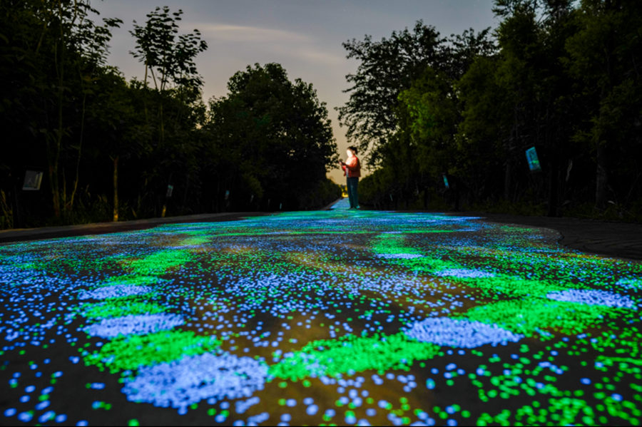 Fluorescent footpath glows under the night sky in Chongqing