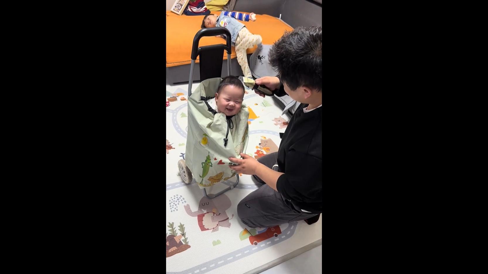 Baby gets haircut in a shopping trolley bag
