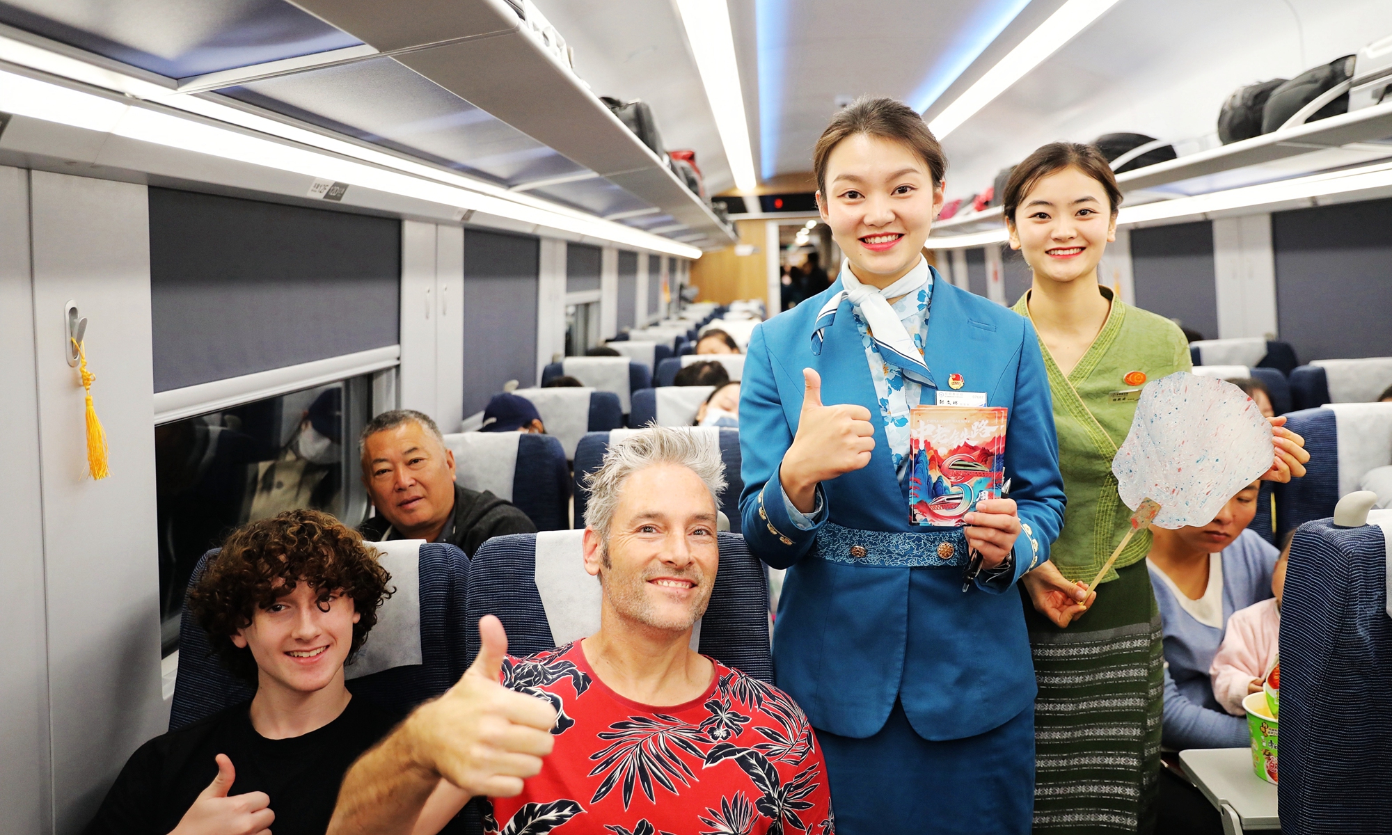 Australian travelers take a picture with train attendants when riding the China-Laos Railway passenger train from Vientiane, Laos to Kunming, capital of Southwest China's Yunnan Province on March 2, 2025. Photo: China Railway Kunming Group Co