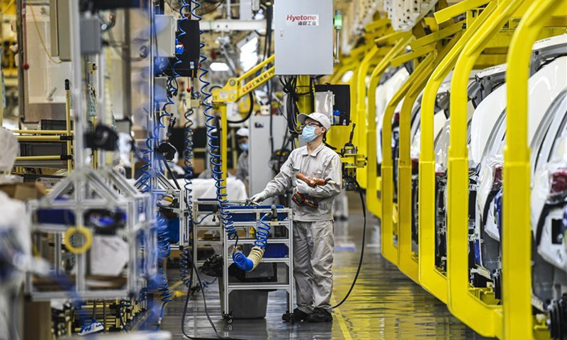Workers are busy at the Xinjiang car plant of GAC Motor in Urumqi, northwest China's Xinjiang Uygur Autonomous Region, Sept. 24, 2020. Urumqi has made efforts to propel the transformation and upgrading of its equipment manufacturing sector. A modern industrial system with a focus on intelligent, green and customized manufacturing is gradually taking shape in the city. At present, Xinjiang is home to more than 40 enterprises of scale in developing intelligent manufacturing. (Xinhua/Wang Fei)